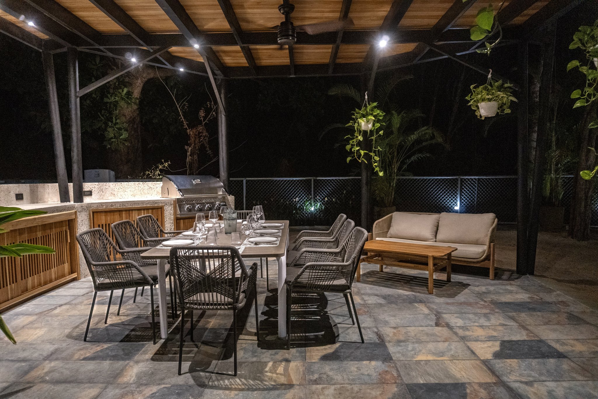 Rancho with BBQ and long dining table at night