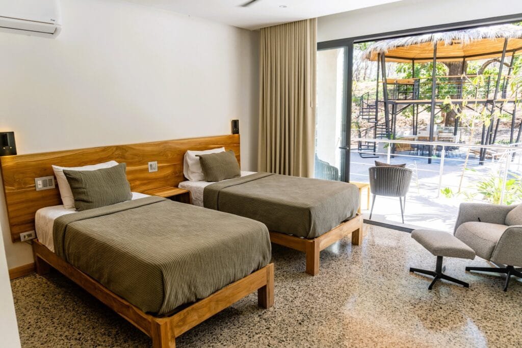 Habitación con camas individuales del apartamento Lapa, con balcón privado y vista al rancho