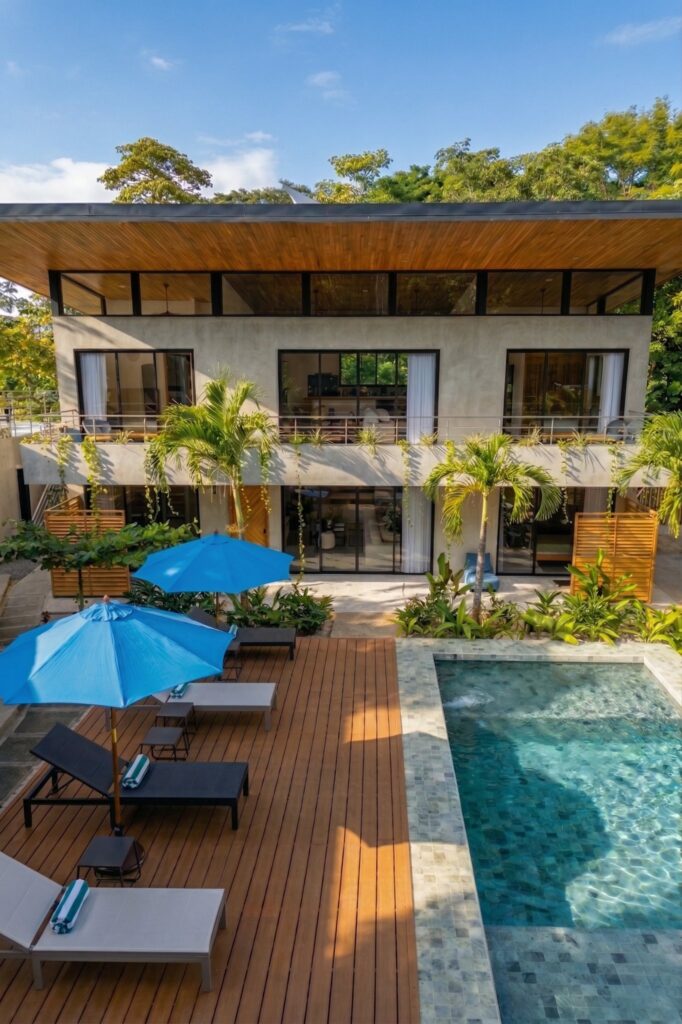 Nori Villas building exterior with poolside loungers and umbrellas